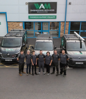 The WAM team and fleet of vans in front of the depo